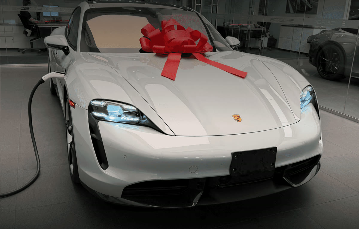 White Porsche Taycan with a red bow