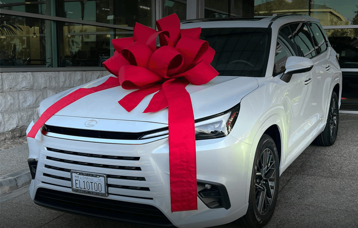 White Lexus with a red bow