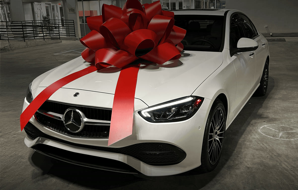 White Mercedes-Benz with a red bow