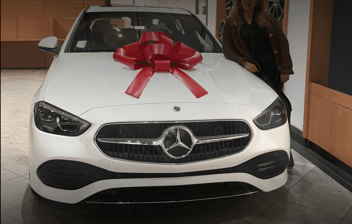 White Mercedes-Benz with a red bow